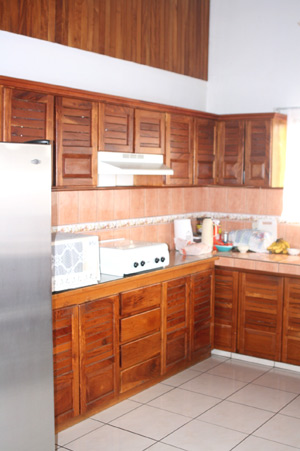 The kitchen, like the rest of the apartment has a high ceiling and attractive custom woodwork.
