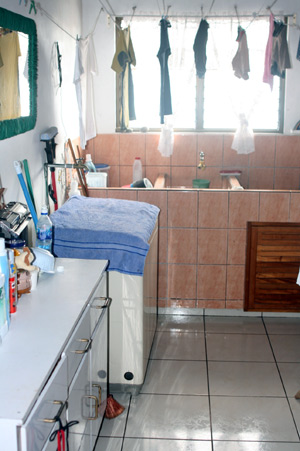 The apartment has a large laundry room with built-in pila.