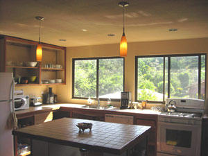 The kitchen is a roomy place with large windows and a center island.