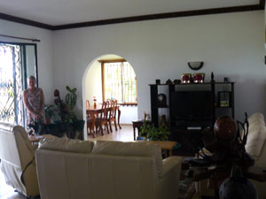 The living room is a very large room opening through wide glassed doors to the broad covered patio.