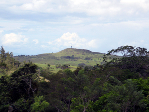 Between the nearby forest and the cross-topped mountain hides the town of Tilaran.