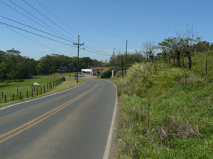 In this view back along the highway  toward the Lago Arenal gas station, the lower edge of the lot shows on the right. 